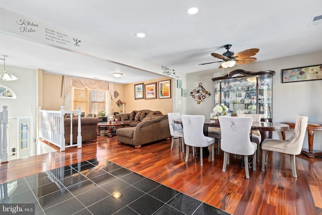 dining space with ceiling fan and dark hardwood / wood-style flooring