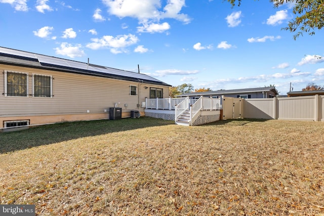 view of yard featuring a wooden deck and cooling unit