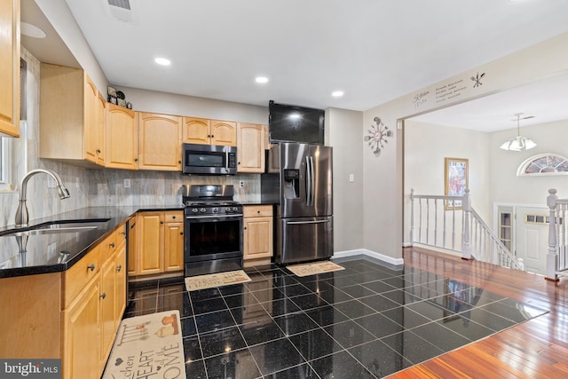 kitchen featuring light brown cabinetry, tasteful backsplash, sink, a notable chandelier, and stainless steel appliances