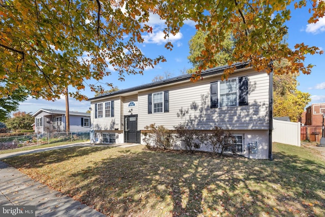 raised ranch with a front yard