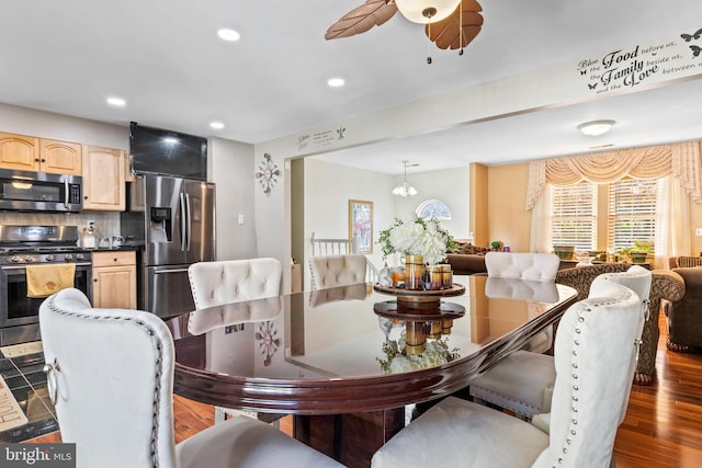 dining space with wood-type flooring and ceiling fan