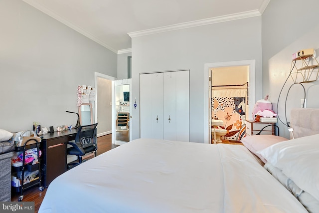 bedroom featuring crown molding, ensuite bath, dark hardwood / wood-style floors, and a closet