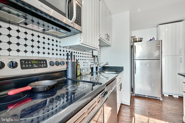 kitchen featuring white cabinetry, appliances with stainless steel finishes, and dark hardwood / wood-style flooring