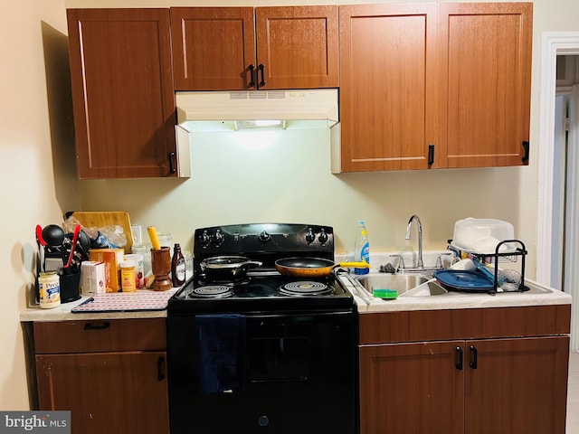 kitchen featuring black electric range oven and sink