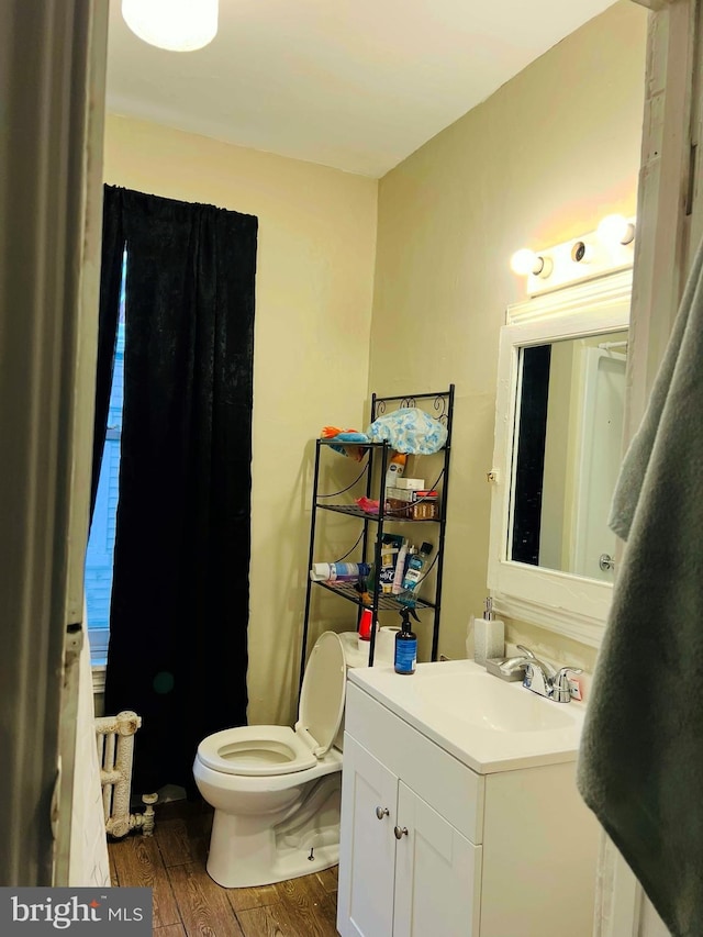 bathroom featuring hardwood / wood-style flooring, vanity, and toilet