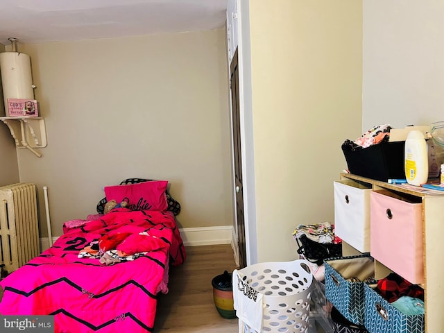 bedroom featuring wood-type flooring and radiator