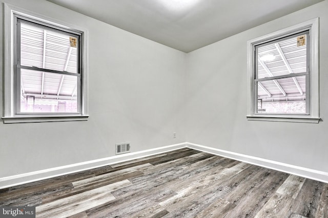 unfurnished room featuring hardwood / wood-style flooring