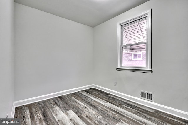 empty room featuring dark wood-type flooring