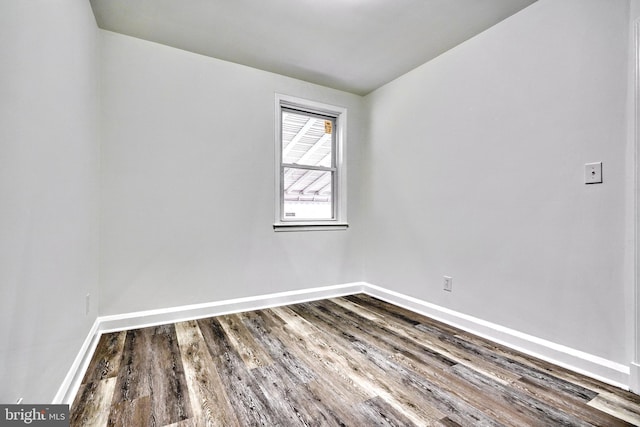 spare room with wood-type flooring