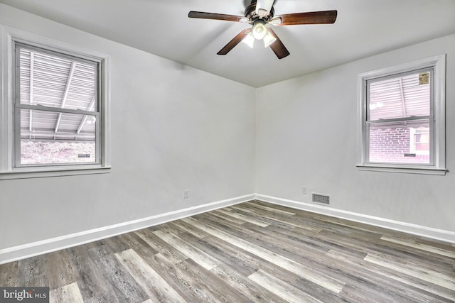 empty room featuring hardwood / wood-style floors and ceiling fan