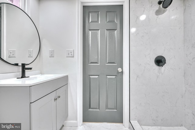 bathroom featuring vanity and tiled shower