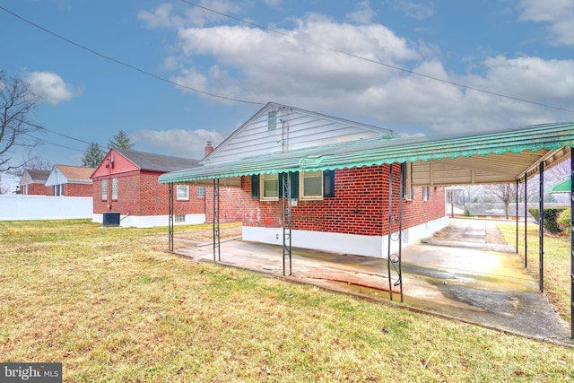 rear view of property featuring a yard and cooling unit