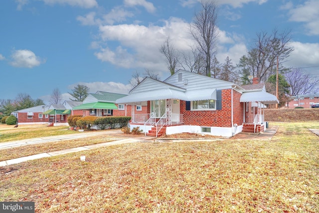 bungalow-style house with a front yard