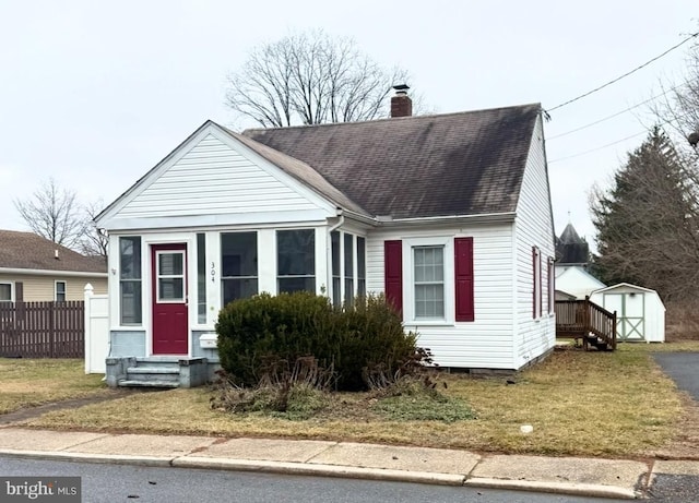 bungalow featuring a shed and a front yard