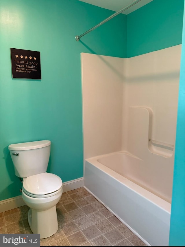 bathroom featuring bathtub / shower combination and toilet