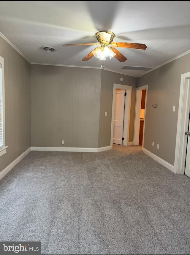 carpeted empty room with crown molding and ceiling fan