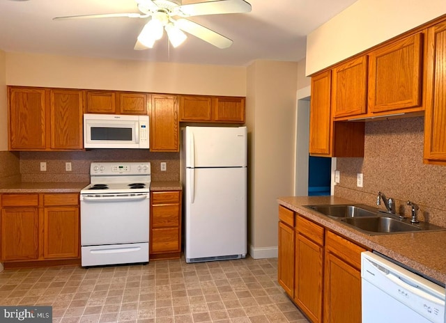 kitchen with tasteful backsplash, ceiling fan, sink, and white appliances