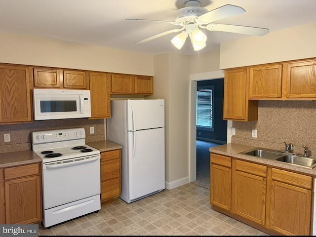 kitchen with tasteful backsplash, white appliances, ceiling fan, and sink