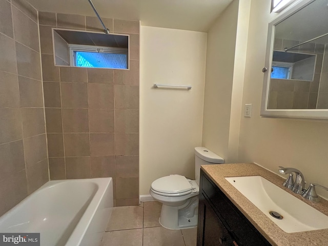 full bathroom featuring vanity, tiled shower / bath, tile patterned floors, and toilet