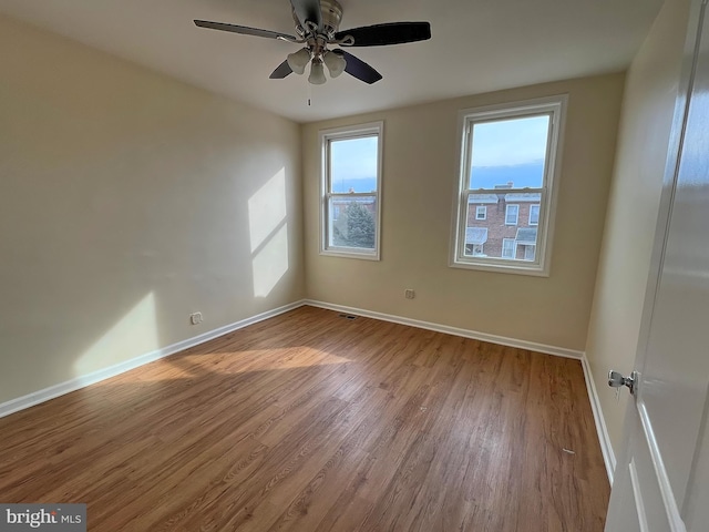 empty room featuring ceiling fan and light hardwood / wood-style flooring