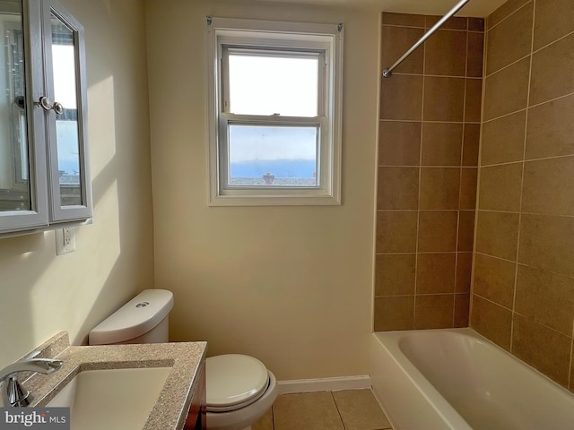 full bathroom featuring vanity, toilet, tiled shower / bath combo, and tile patterned flooring