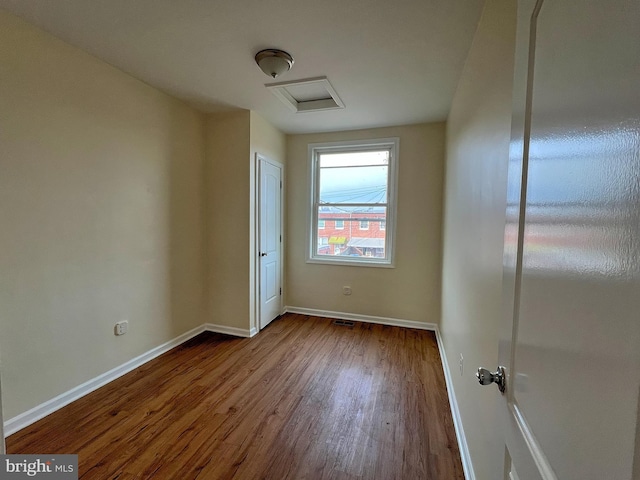 unfurnished room with wood-type flooring