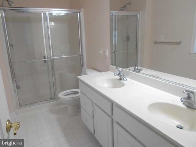 bathroom with walk in shower, tile patterned floors, vanity, and toilet