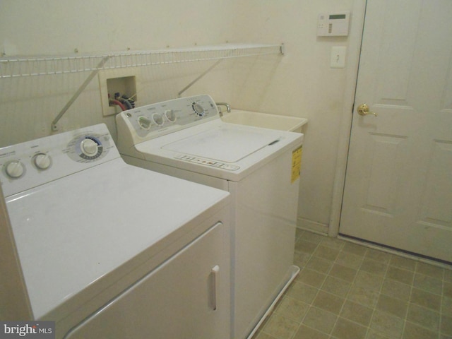 washroom featuring sink and washer and dryer