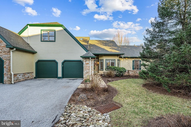 view of front of home with a garage and a front yard