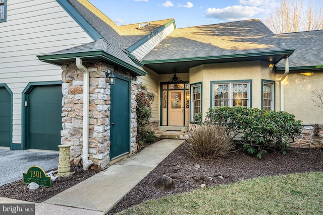 doorway to property with a garage