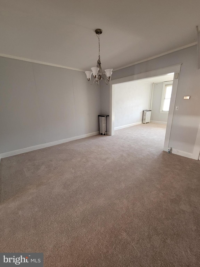 unfurnished room with ornamental molding, carpet, radiator heating unit, and an inviting chandelier