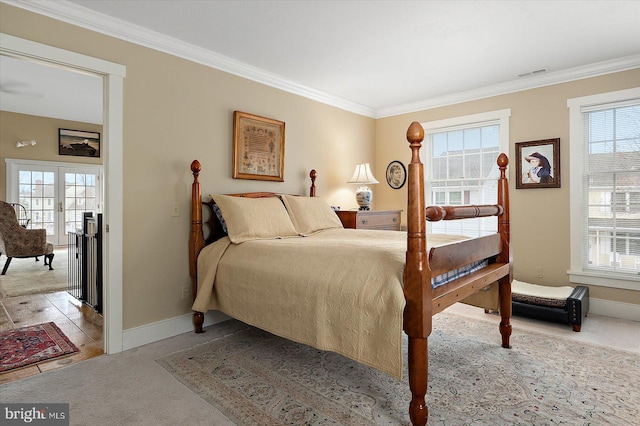 bedroom with crown molding, light carpet, and french doors