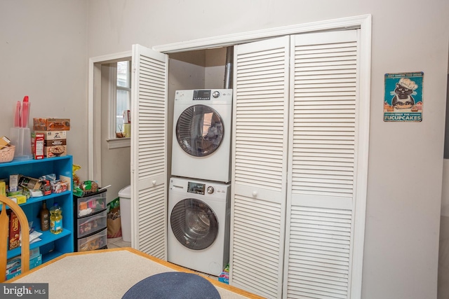 washroom featuring laundry area and stacked washer / dryer