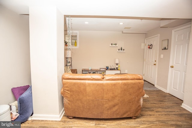 living area with baseboards, recessed lighting, and wood finished floors