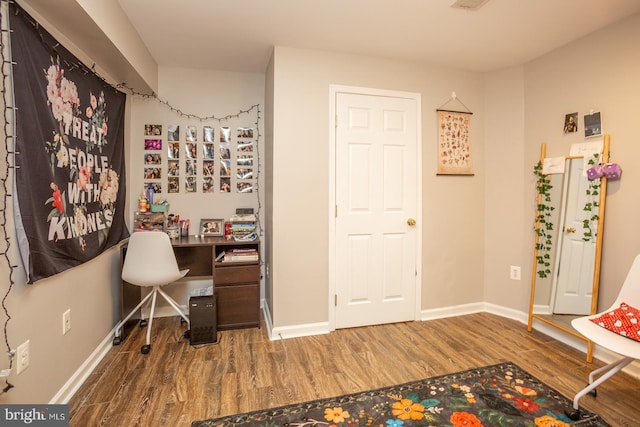 interior space featuring baseboards and wood finished floors