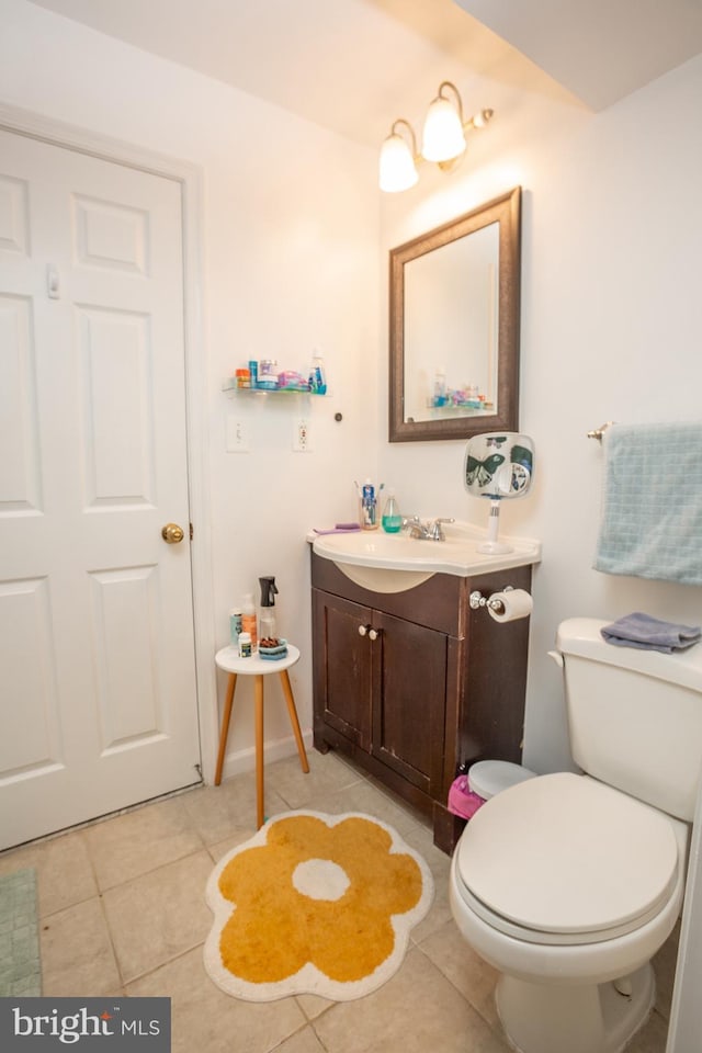 bathroom featuring toilet, tile patterned flooring, and vanity
