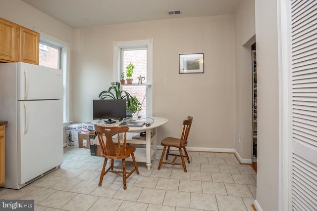 dining space with visible vents, baseboards, and light tile patterned flooring