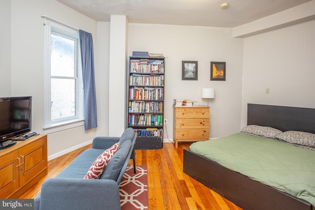 bedroom featuring light wood-type flooring and baseboards
