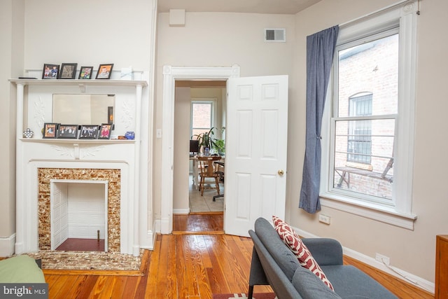 interior space with visible vents, baseboards, and hardwood / wood-style floors