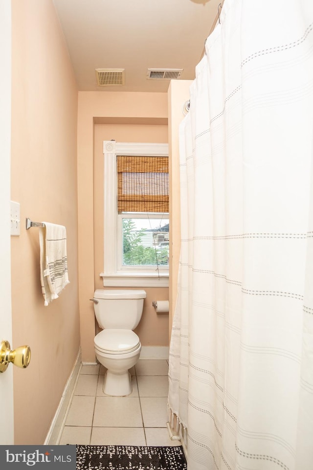 bathroom with tile patterned flooring, toilet, baseboards, and visible vents