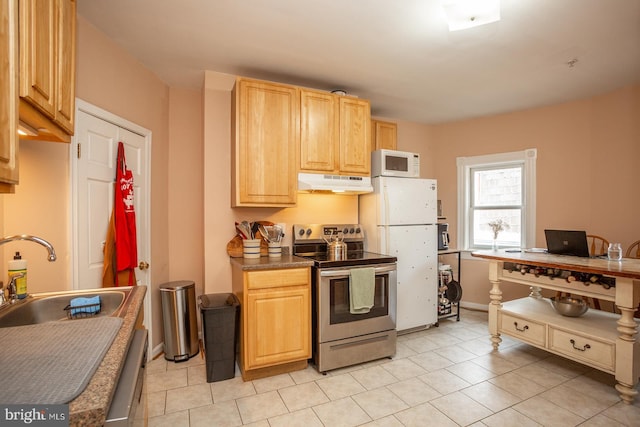 kitchen featuring light tile patterned floors, white appliances, light brown cabinetry, and under cabinet range hood