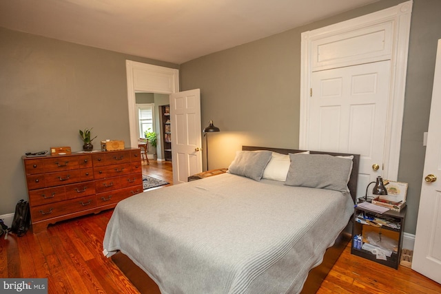 bedroom featuring baseboards and wood finished floors