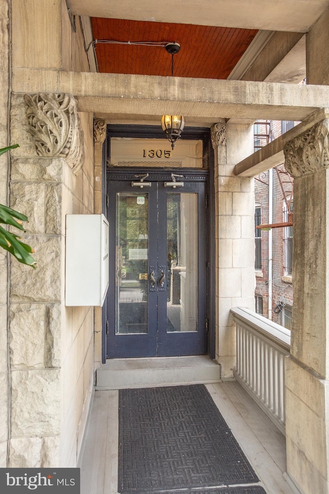 entrance to property with stone siding and french doors