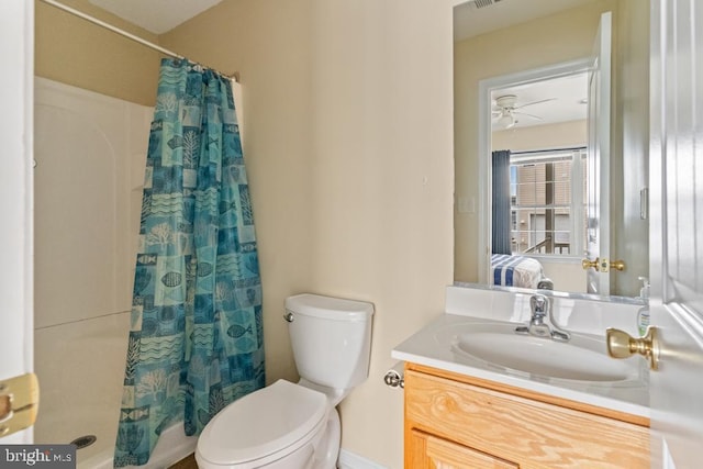 bathroom featuring a shower with curtain, vanity, and toilet