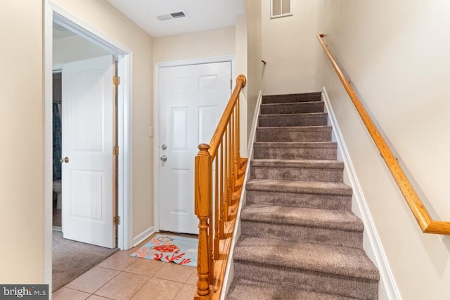 stairway featuring tile patterned floors