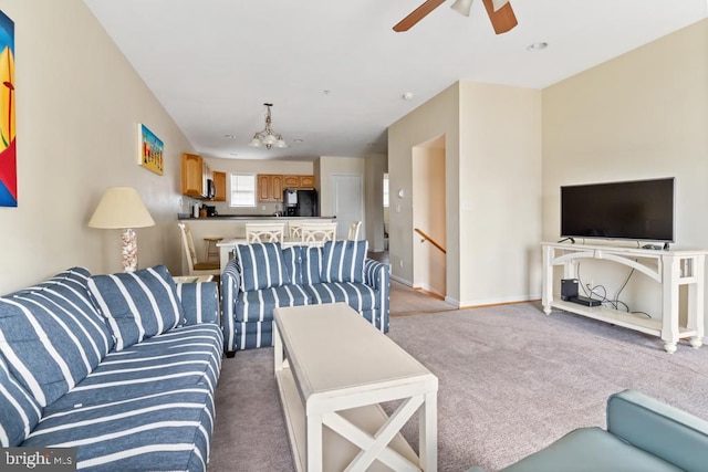 living room with light carpet and ceiling fan