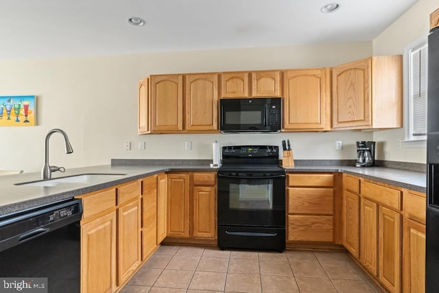 kitchen with sink, black appliances, and light tile patterned flooring