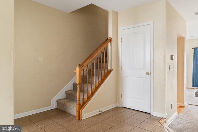 stairs with tile patterned flooring