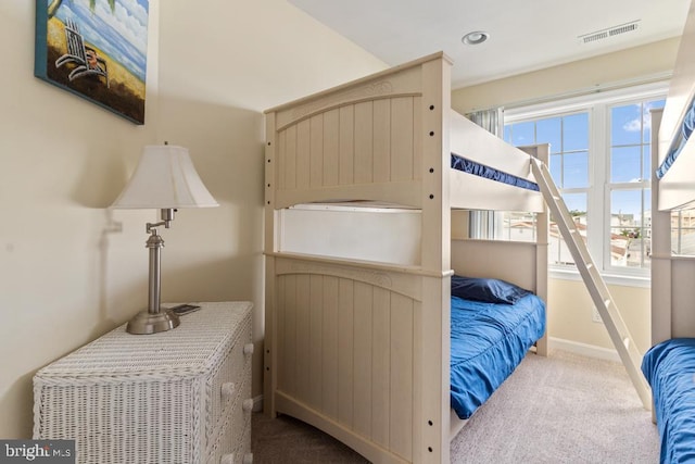 carpeted bedroom with multiple windows