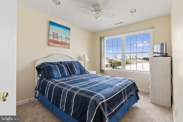 bedroom with light carpet and ceiling fan